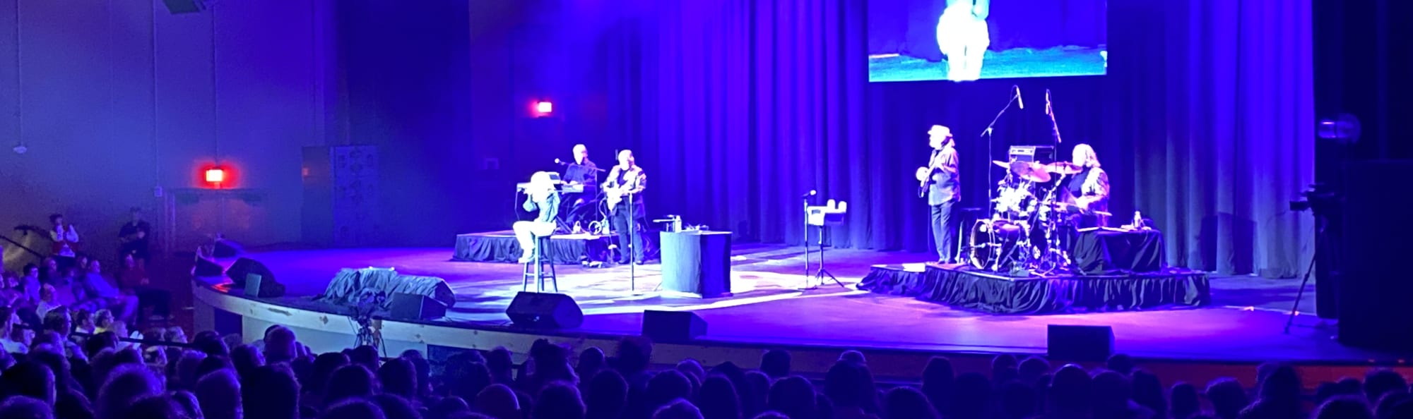 signer on stage in chair washed out by the lights Seattle